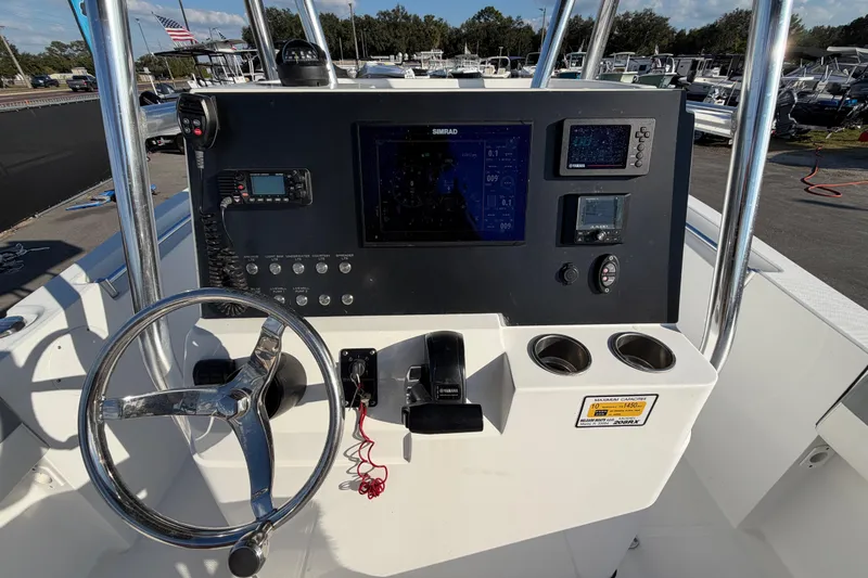 Slide: The Image of 2019 Release 208RX boat console with steering wheel, navigation system, and control panel. - 23