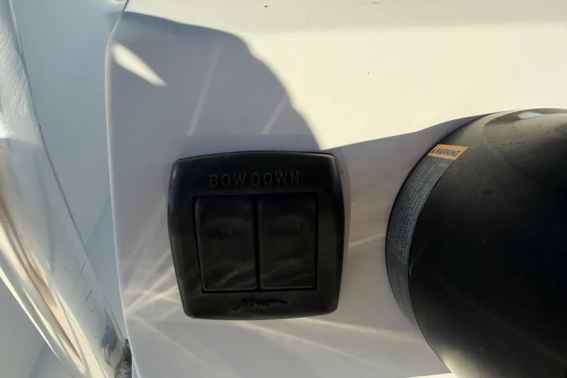 Slide: The Image of Control panel on 2019 Release 208RX boat with "Bow Down" button. - 24