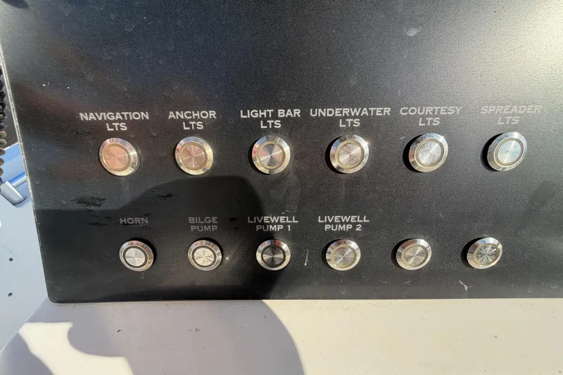 Slide: The Image of Control panel of a 2019 Release 208RX boat with labeled switches for various functions. - 25