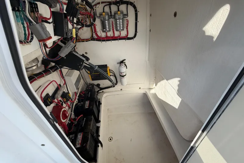 Slide: The Image of Electrical compartment of 2019 Release 208RX boat with wiring and batteries. - 34