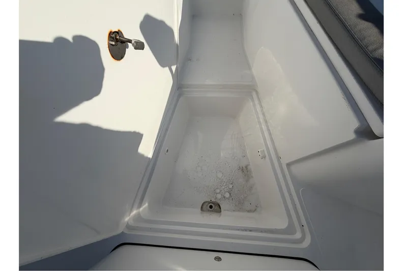Slide: The Image of 2019 Release 208RX boat storage compartment with shadows and latch detail. - 39