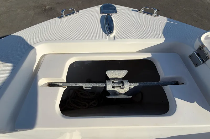 Slide: The Image of Bow anchor compartment of 2019 Release 208RX boat with anchor and rope. - 45