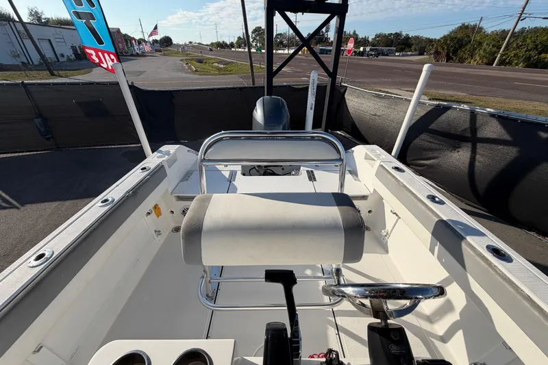 Slide: The Image of 2019 Release 208RX boat interior with steering wheel and seating, displayed outdoors. - 54