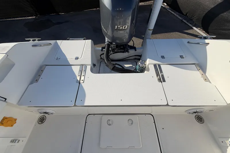 Slide: The Image of 2019 Release 208RX boat deck with Yamaha 150 engine, featuring storage compartments. - 56