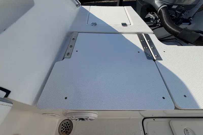Slide: The Image of 2019 Release 208RX boat deck with storage compartments and engine components. - 57