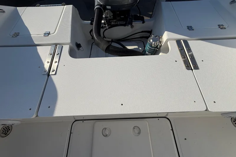 Slide: The Image of 2019 Release 208RX boat deck with storage compartments and engine components. - 60