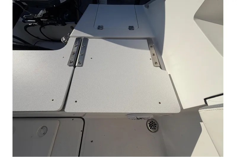 Slide: The Image of 2019 Release 208RX boat deck with textured surface and metal hinges. - 63