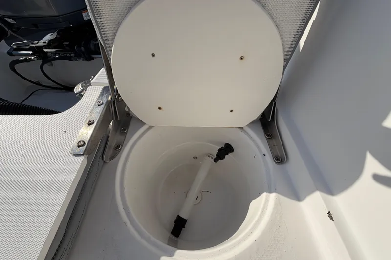 Slide: The Image of Open storage compartment in 2019 Release 208RX boat, showing interior details and fittings. - 65