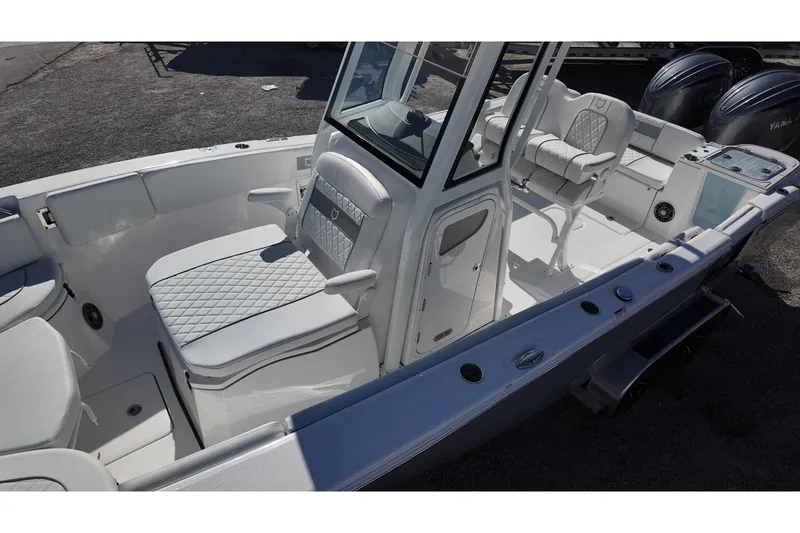 Slide: The Image of 2026 Sea Fox 268 Commander boat interior with white seating and dual engines. - 11