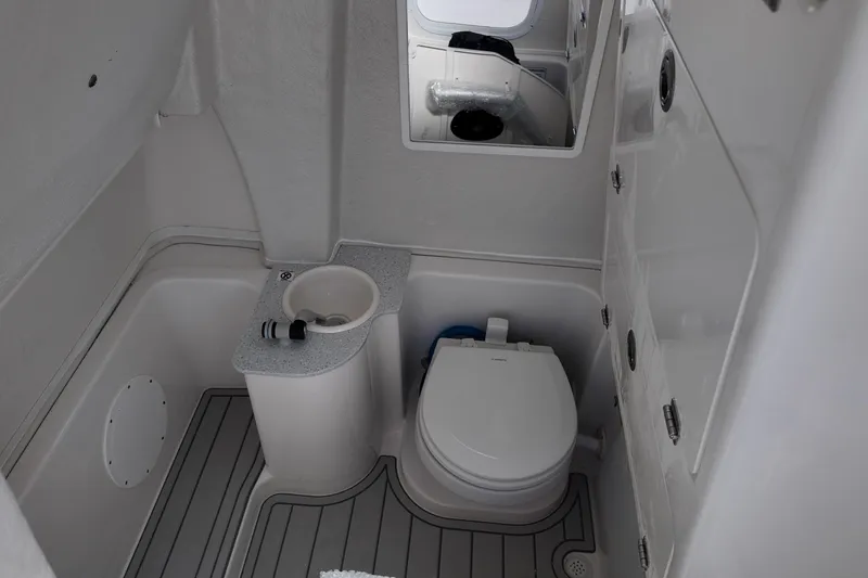 Slide: The Image of 2026 Sea Fox 268 Commander boat bathroom with toilet and sink, featuring modern design. - 13