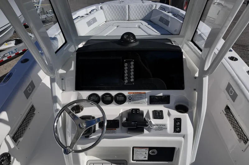 Slide: The Image of 2026 Sea Fox 268 Commander boat dashboard with steering wheel and control panel. - 16