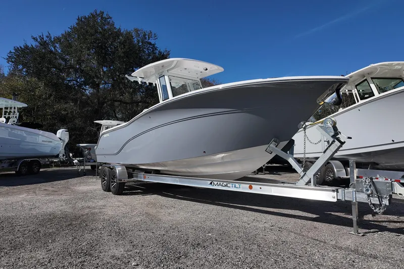 Slide: The Image of 2026 Sea Fox 268 Commander boat on trailer, parked outdoors under clear blue sky. - 2