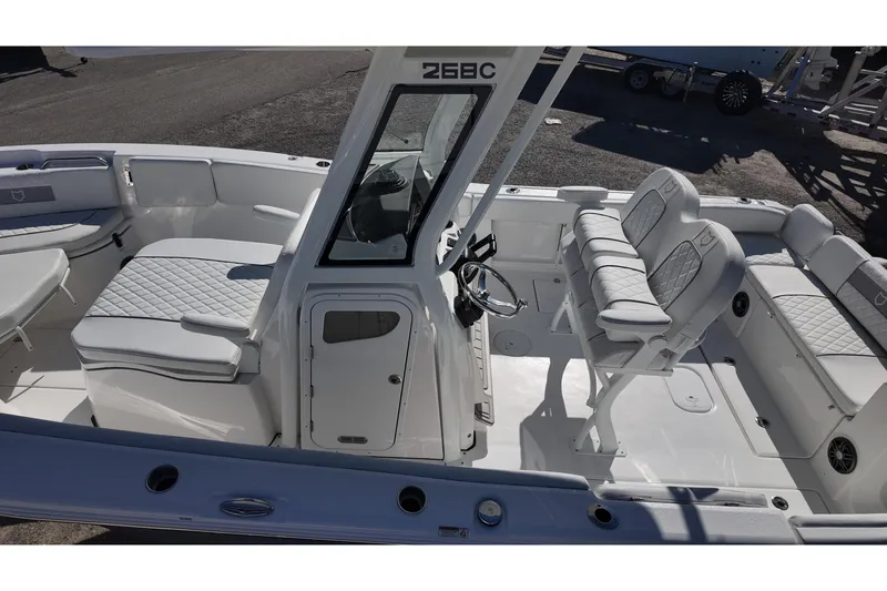Slide: The Image of 2026 Sea Fox 268 Commander boat interior with cushioned seating and steering console. - 21