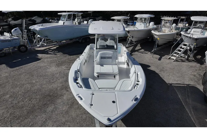 Slide: The Image of 2026 Sea Fox 268 Commander boat displayed in a marina, surrounded by other vessels. - 9