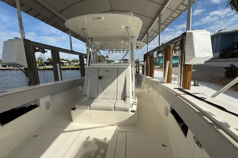 Slide: The Image of 2019 SeaVee 390Z boat interior, featuring spacious seating and sleek design by the water. - 32