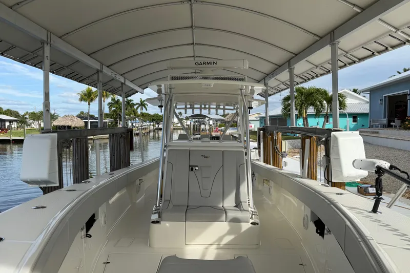 Slide: The Image of 2019 SeaVee 390Z boat interior with helm seating, hard top T-top and Garmin Radar. - 33