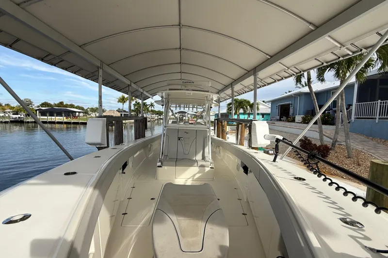 Slide: The Image of 2019 SeaVee 390Z boat docked under canopy, featuring spacious deck and modern design. - 36