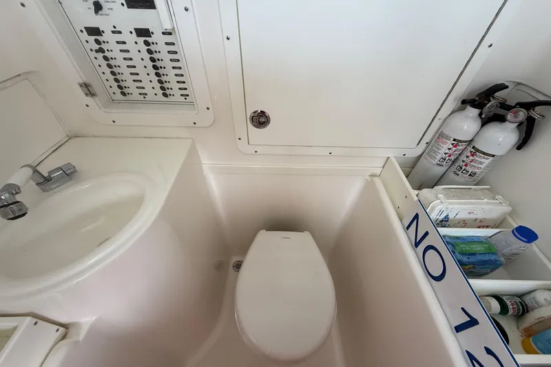 Slide: The Image of 2019 SeaVee 390Z boat bathroom with sink, toilet, and safety equipment. - 39