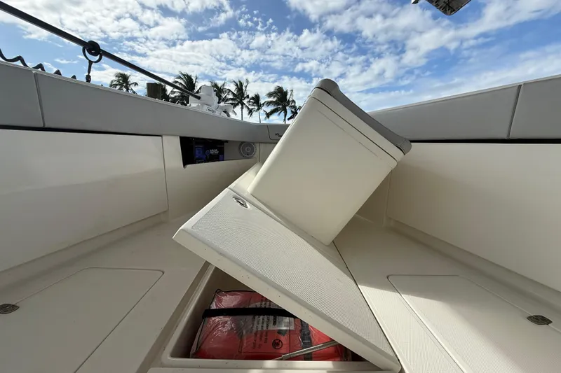 Slide: The Image of 2019 SeaVee 390Z boat interior with open storage compartment under center lounger - 48