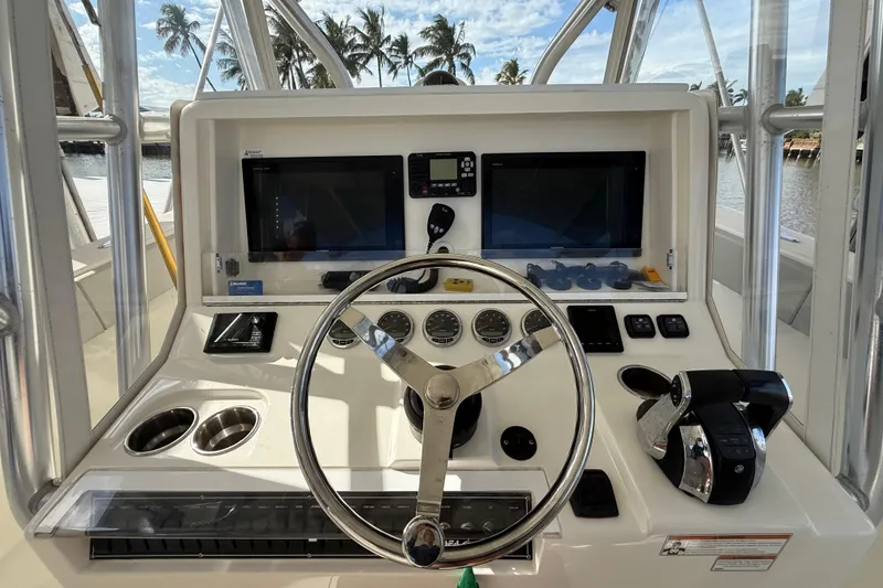 Slide: The Image of 2019 SeaVee 390Z boat dashboard with steering wheel, controls, and dual screens. - 6