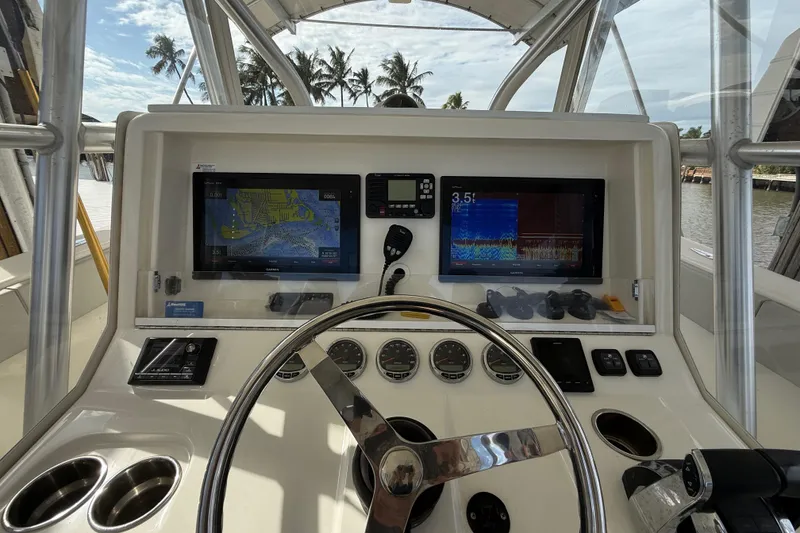 Slide: The Image of 2019 SeaVee 390Z boat dashboard with navigation screens and steering wheel. - 7
