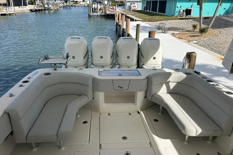 Slide: The Image of 2019 SeaVee 390Z boat with quad engines, docked by a waterfront. - 80