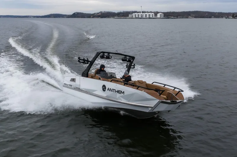 Slide: The Image of 2026 Anthem Assault ST23 boat cruising on a lake with two passengers. - 0