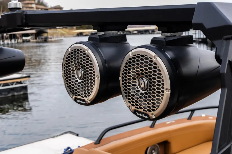 Slide: The Image of 2026 Anthem Assault ST23 boat speakers by the water, featuring Rockford Fosgate audio. - 10