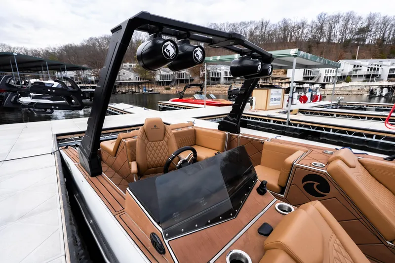 Slide: The Image of Luxurious 2026 Anthem Assault ST23 boat with tan interior at a marina dock. - 11
