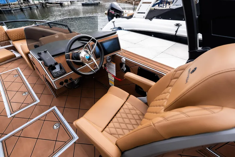 Slide: The Image of Luxurious interior of 2026 Anthem Assault ST23 boat with tan leather seating and modern dashboard. - 13