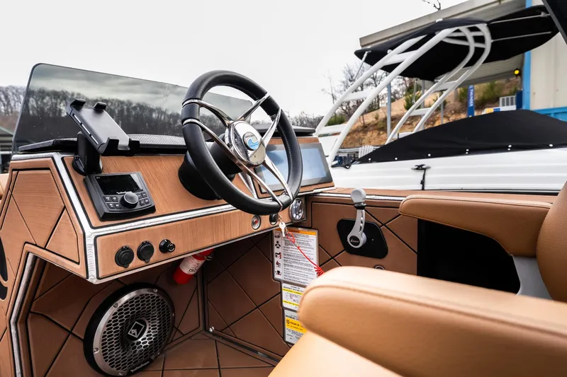 Slide: The Image of 2026 Anthem Assault ST23 boat interior with steering wheel and control panel. - 17