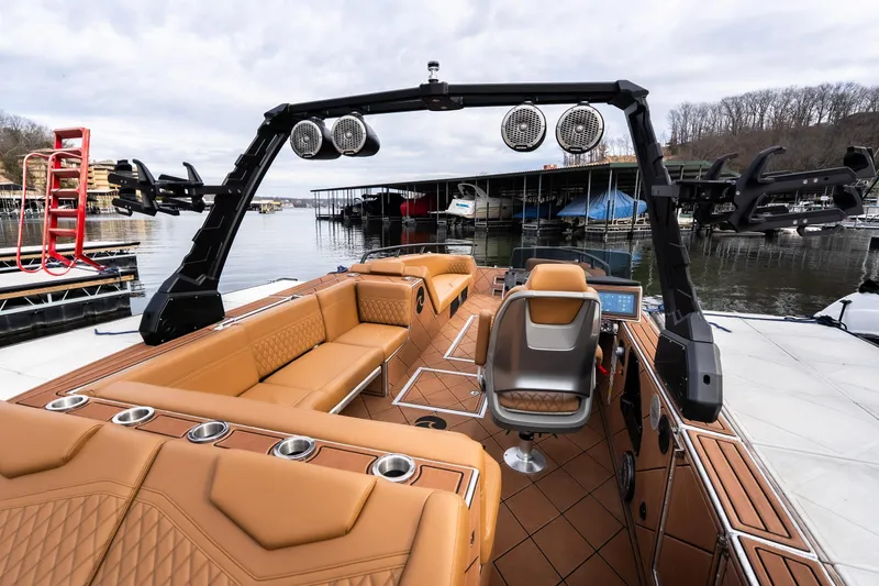 Slide: The Image of Luxurious 2026 Anthem Assault ST23 boat interior with tan seating and advanced audio system. - 20