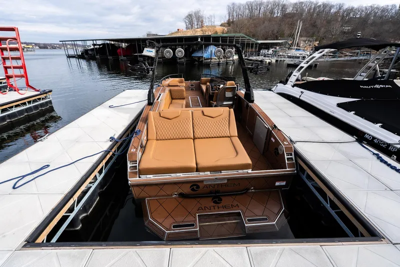 Slide: The Image of Luxury Anthem Assault ST23 boat docked at marina, showcasing sleek design and comfortable seating. - 29