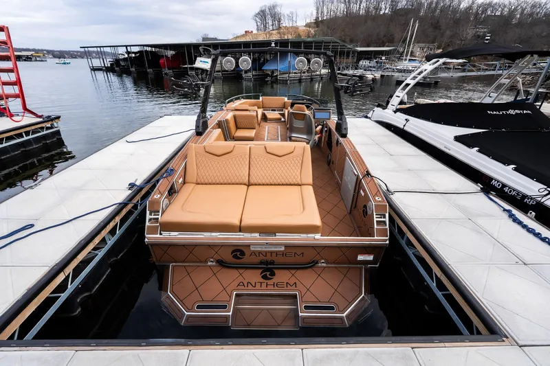 Slide: The Image of 2026 Anthem Assault ST23 boat docked, featuring luxurious tan seating and modern design. - 5