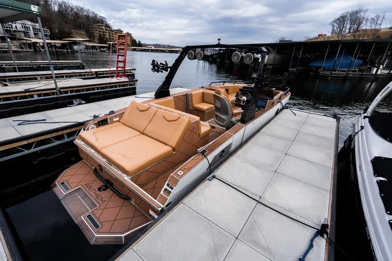 Slide: The Image of 2026 Anthem Assault ST23 boat docked, featuring luxurious tan seating and modern design. - 6