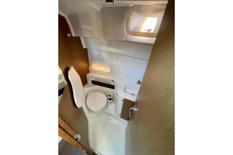 Slide: The Image of Compact bathroom in 2020 Beneteau Antares 9 boat, featuring toilet, sink, and window. - 12