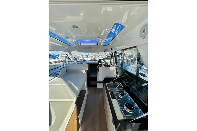 Slide: The Image of Interior of 2020 Beneteau Antares 9 boat, featuring modern seating and kitchen area. - 18