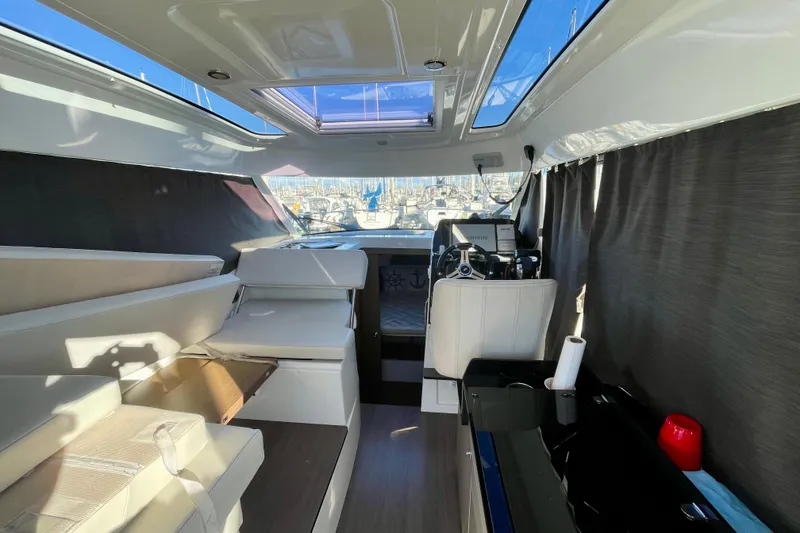 Slide: The Image of Interior of 2020 Beneteau Antares 9 boat, featuring helm and seating area. - 19