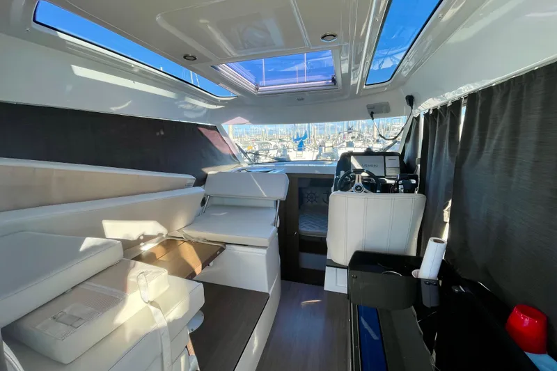 Slide: The Image of Interior of 2020 Beneteau Antares 9 boat, featuring modern seating and navigation area. - 20