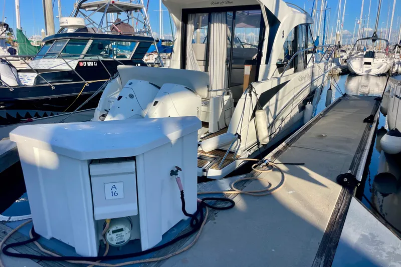 Slide: The Image of 2020 Beneteau Antares 9 docked at marina, surrounded by other boats. - 31