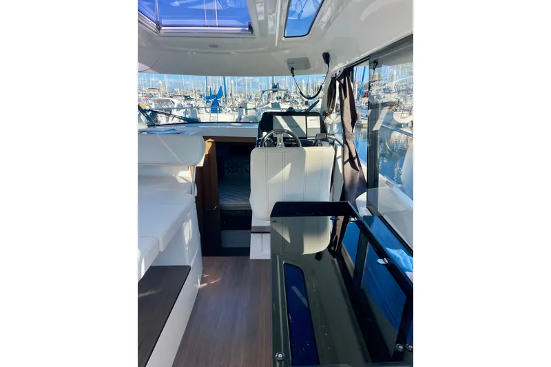 Slide: The Image of Interior view of 2020 Beneteau Antares 9 boat, featuring seating and windows. - 8