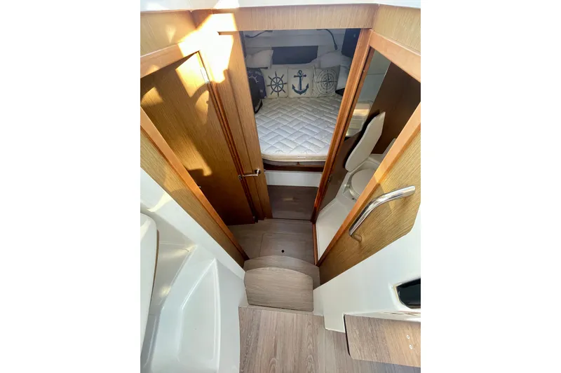 Slide: The Image of Interior of 2020 Beneteau Antares 9, featuring cozy cabin with nautical-themed decor. - 9