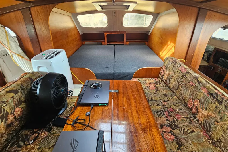 Slide: The Image of Interior of a 1973 Prout 35 boat with cozy seating and a bed. - 15
