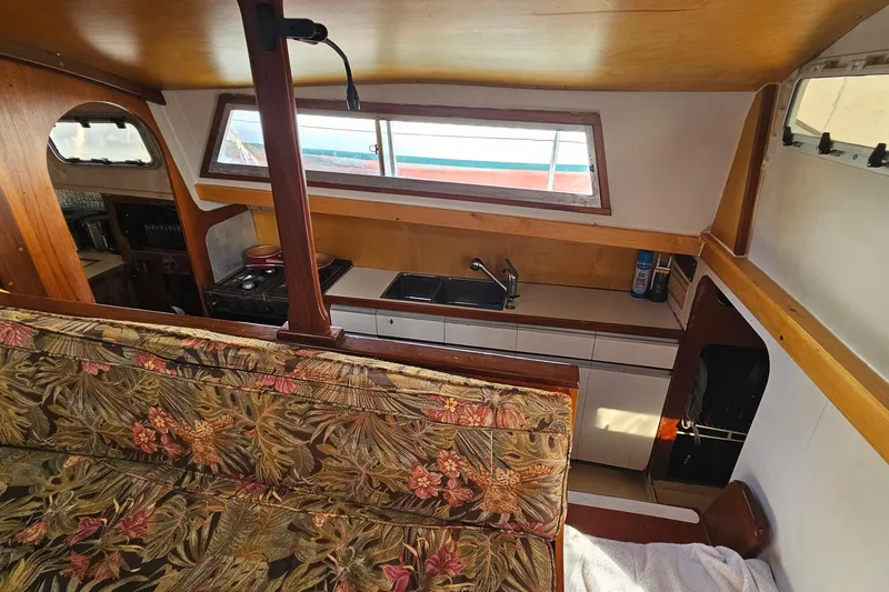 Slide: The Image of Interior of 1973 Prout 35 sailboat showing compact bathroom with sink and toilet. - 18