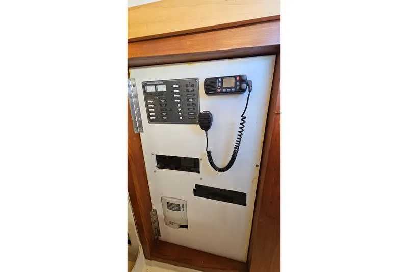 Slide: The Image of Interior of a 1973 Prout 35 sailboat with wooden furnishings and floral upholstery. - 21