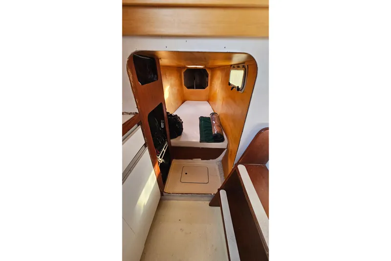 Slide: The Image of 1973 Prout 35 yacht kitchen with stove, sink, and wooden cabinetry. - 26