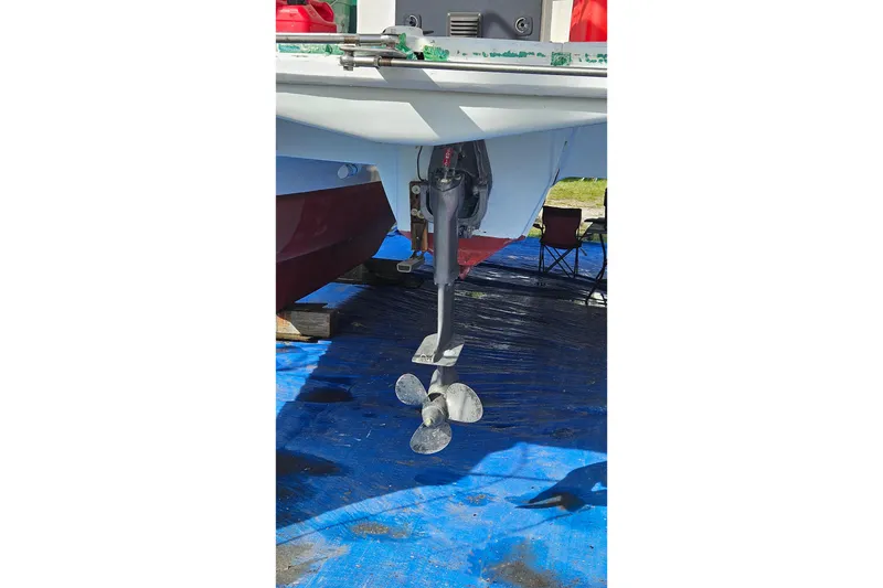 Slide: The Image of 1973 Prout 35 boat hull, under maintenance, with reflective surface and outdoor setting. - 33