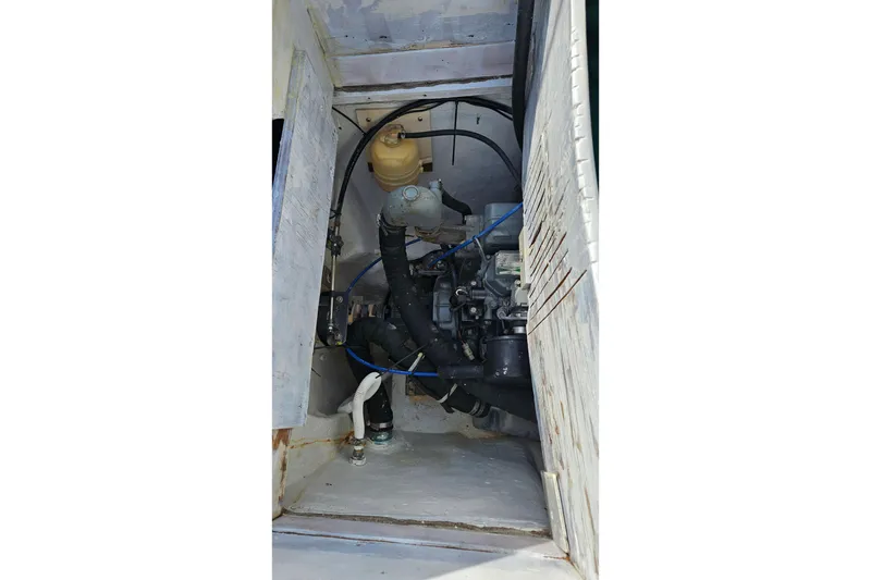 Slide: The Image of 1973 Prout 35 sailboat deck with green canopy, docked among other boats. - 4