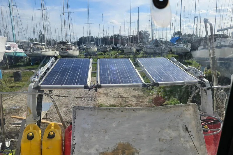 Slide: The Image of Sailboat with solar panels in a marina, Prout 35, 1973 model. - 40
