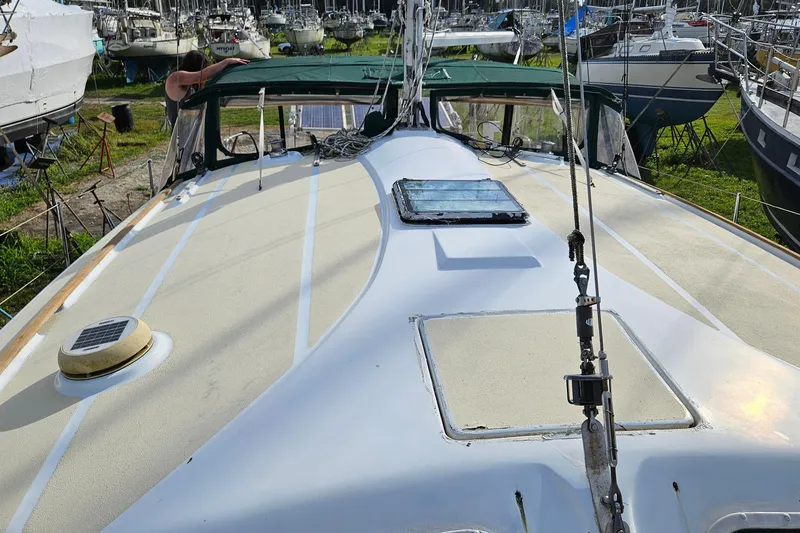 Slide: The Image of 1973 Prout 35 sailboat on land, surrounded by trees and other boats. - 5